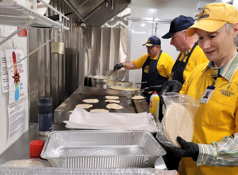 An SBTC DR QRU crew prepares meals for volunteers and survivors